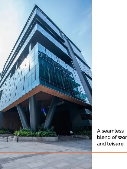 A low-angle shot of The V Park's facade, emphasizing its scale and modern aesthetic. The design creates a seamless blend of work and leisure, setting a new benchmark for business campuses in India.