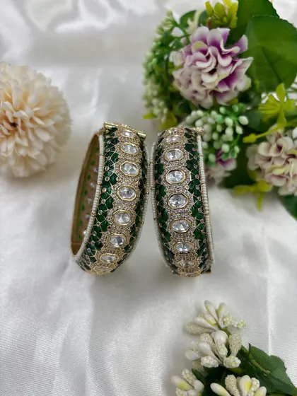 The Sitara openable bangles, featuring green Meenakari work and set with high-quality Moissanite Kundan. The video shows the secure and easy-to-use clasp.