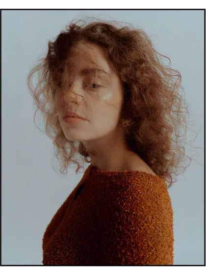 A soft, emotive portrait for Flanelle Magazine, with the model's hair gently blowing across her face.