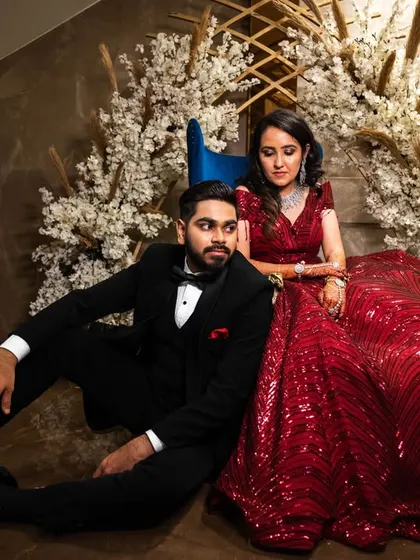 An editorial-style pose with the couple seated. This creates a relaxed yet stylish portrait, perfect for a modern wedding album.