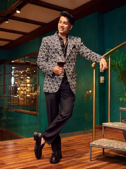This jacket is designed to make an entrance. The black and white woven fabric creates a stunning visual texture, perfect for a high-fashion cocktail party or a celebratory event. I paired it with a simple black shirt to let the jacket be the hero of the outfit.