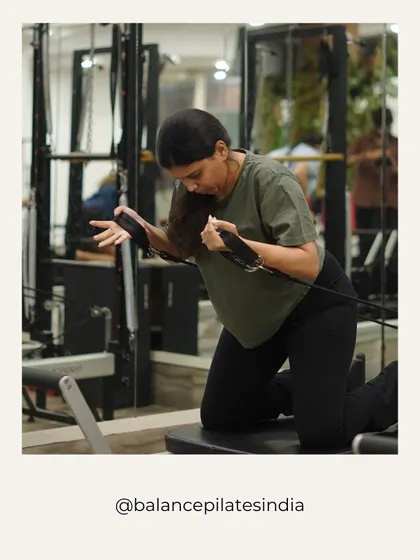 A moment of focus. This client is working her arms and back, building strength with the reformer's resistance.