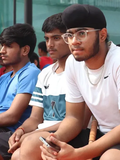Players watch intently from the sidelines, fully engaged in the match. Every member of our club is a student of the game, always learning and supporting one another.