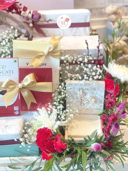 Another angle of the chocolate-loaded hamper, showing the artful arrangement of gift boxes and flowers.