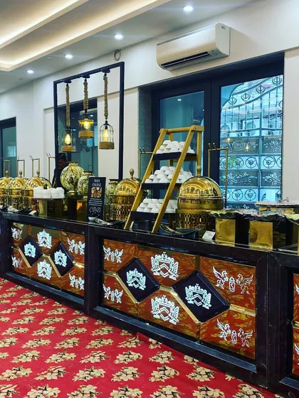 An indoor buffet line ready for a corporate luncheon. The combination of our decorative counter, golden chafing dishes, and multi-level displays creates a dynamic and appealing food presentation.