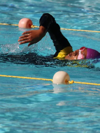 A young swimmer demonstrates the arm pull phase of the freestyle stroke. Our coaches provide detailed feedback to help students refine every part of their technique.