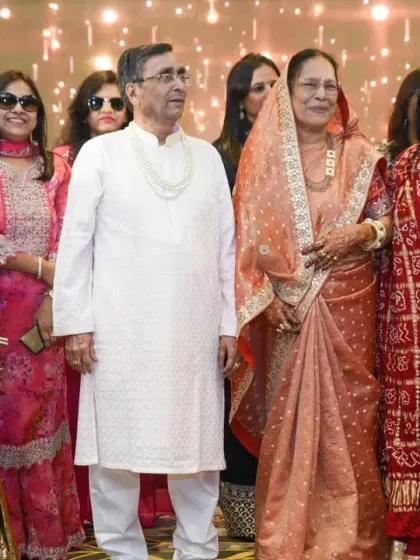 A candid shot of the couple enjoying the festivities with their family.