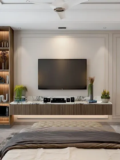 The TV wall in the Vasant Kunj bedroom, featuring classic wall molding and a floating console, creating a clean and timeless look.