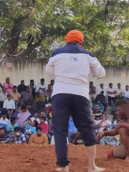 Observing a Kusti match closely. The focus and intensity in the pit are a sight to behold.