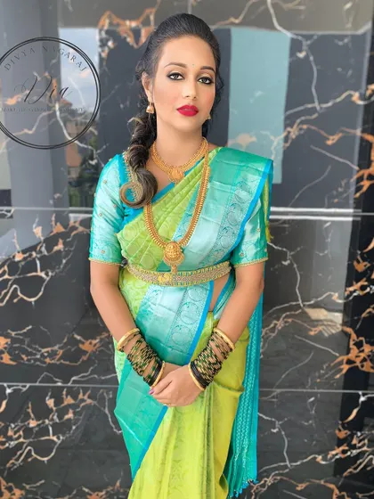 The complete engagement look. The bride looks stunning and confident in her vibrant saree, with makeup that enhances her features perfectly. This is a great example of a classic engagement day style.