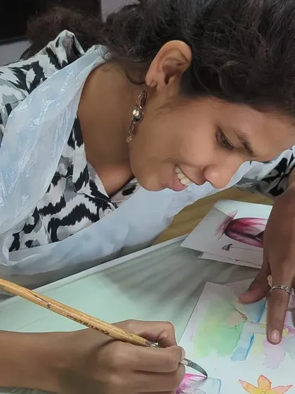 A participant engrossed in her watercolor painting. Our studio is a space for focus, relaxation, and creativity.