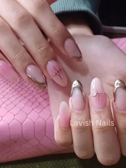 An elegant chrome-tipped French manicure on long oval nails with subtle star and bow accents.