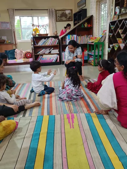 A child interacts with the storyteller, a common and encouraged part of our sessions.