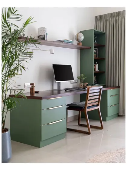 The main work-from-home desk in the study, combining a rich walnut top with olive green drawers. The spacious desk and ample natural light make it a comfortable and inspiring workspace.