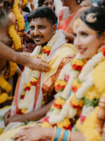 A candid shot of the groom during the Muhurtham, his smile reflecting the joy of the occasion.