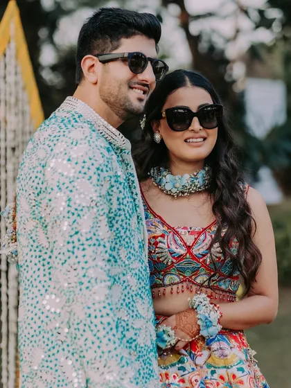 The couple looking cool and stylish in their sunglasses, ready to take on their fun-filled Haldi party.