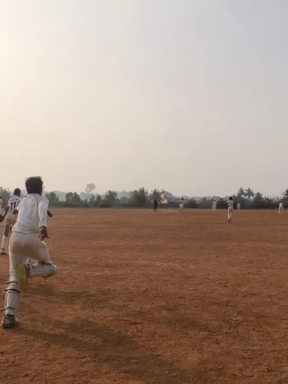 A player runs between the wickets, showcasing the fitness and running technique we emphasize in our training.