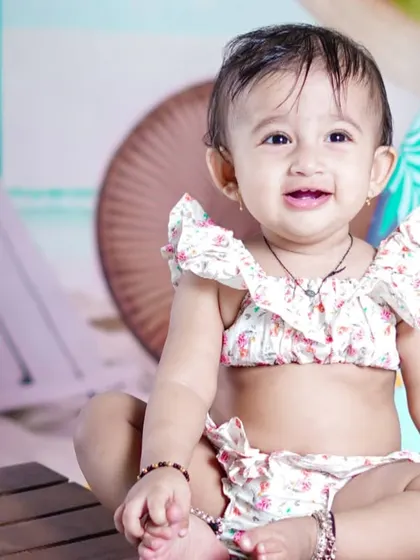 A beautiful, happy close-up portrait that perfectly captures the joy of a first birthday.