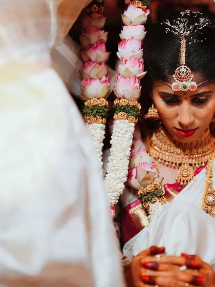 A close-up shot of the bride during a sacred moment in the ceremony, her face serene and focused.