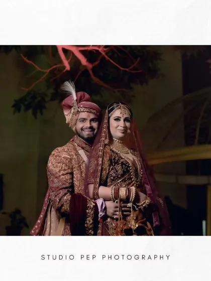 A beautifully composed wide shot of the couple, framed by modern architecture and purple lighting.