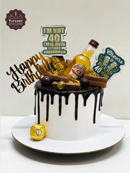 A 40th birthday cake for a husband, featuring a chocolate drip, miniature bottles of Chivas Regal, and fun toppers. It's an overloaded cake perfect for a big celebration.