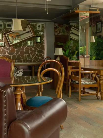 The mix of seating at Echoes, from leather armchairs to wooden dining chairs, creates a dynamic and eclectic environment. This approach avoids uniformity and enhances the feeling of a collected, personal space.