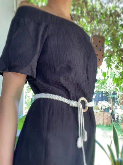 This adjustable macrame belt is a perfect accessory for a simple dress. The off-white cotton stands out and the long tassels add a playful, boho element to the look.