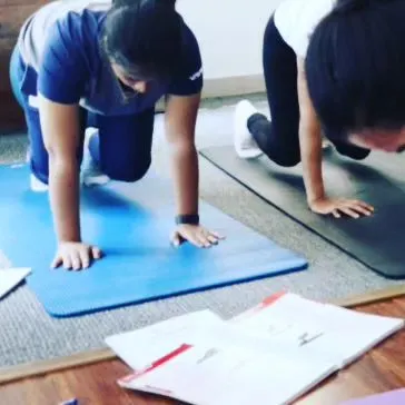 Students engaged in a quadruped exercise during a training session. The course emphasizes learning by doing, with ample time for physical practice.