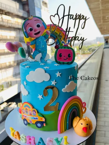 Another delightful Cocomelon cake design for a second birthday. This blue cake is adorned with stars, clouds, rainbows, and a cheerful JJ topper, ready for a fun celebration.