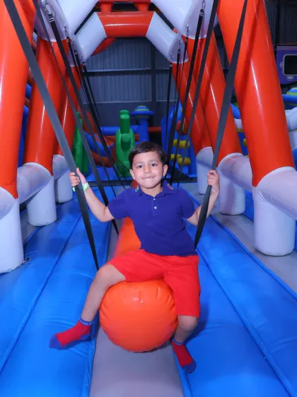 Riding the wrecking ball! This feature of our inflatable course is always a huge hit, perfect for laughs and friendly competition.