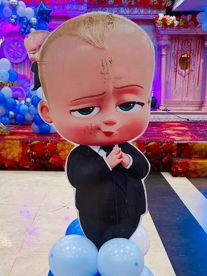 A life-sized 'Boss Baby' character cutout, adding a fun and interactive element to the themed birthday party.