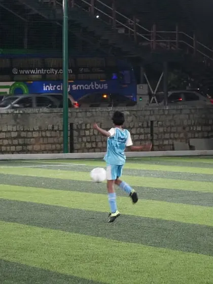 A player executes a perfect volley during a night game, demonstrating skill and precision.