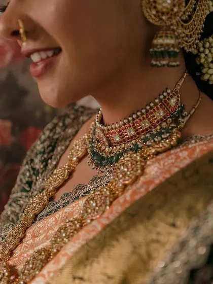 A sneak peek of the bride's look, focusing on the intricate details of her jewelry and the floral background we designed to complement her style.
