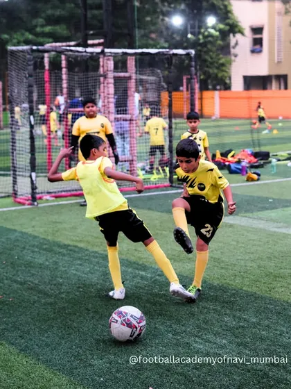 Two young players challenge for the ball, showing the competitive spirit I nurture from a young age.