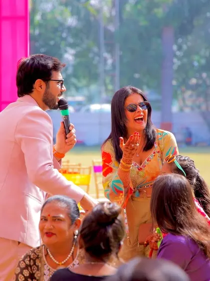 Sharing a laugh with a guest at a Mehendi carnival. My job is to get off the stage and interact directly with your family and friends.
