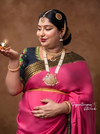A close-up on the mother's glowing face as she holds the lamp, creating a warm and intimate feel.