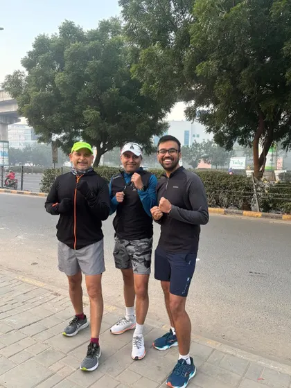 Three runners from the tribe, smiling after a cold but successful training session.