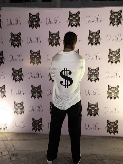 For the man who isn't afraid to make a statement, I designed this custom white party shirt. The bold dollar sign motif on the back is a perfect example of how we can bring any unique idea to life.