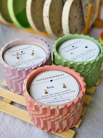 Three of my diamond jar candles in pastel pink, lavender, and green. Each is made with 100% soy wax and comes with a label detailing the fragrance. The eco-resin holders are reusable.