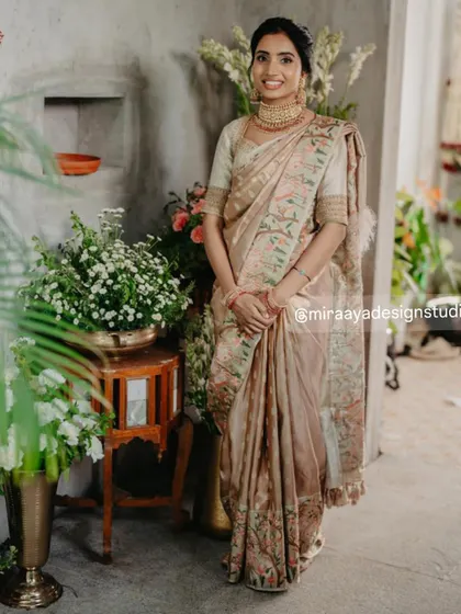 Nithya looking serene and beautiful. Her custom blouse with delicate embroidery is the perfect partner for this elegant, muted-tone silk saree.
