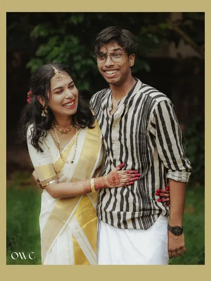 A candid and joyful photo of a couple in traditional Kerala attire.