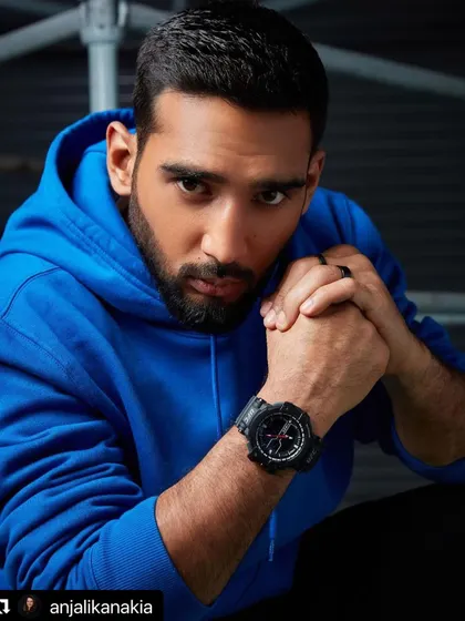 A powerful portrait from the Timex UFC campaign. The model is styled in a simple blue hoodie, with the intense lighting and his direct gaze creating a mood of strength and focus, letting the rugged watch stand out.