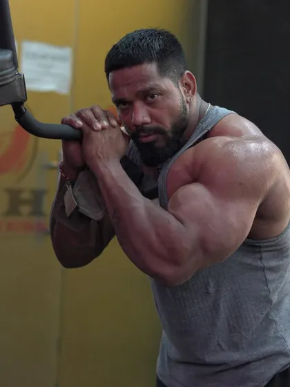 A focused look while posing. The mindset is as important as the muscle.