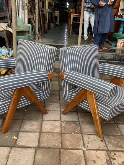 The chairs are shown side-by-side, highlighting their symmetry and the quality of the upholstery work.
