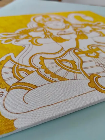 The Anjeneyar/Hanuman painting in its early stages, with a yellow base coat.