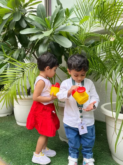 Friends working together to water the plants. We encourage collaborative activities that foster teamwork and a shared sense of responsibility towards nature.