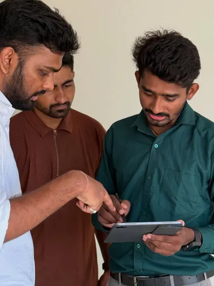 A close-up of our team explaining the finer details of the design plan to the clients on a tablet.