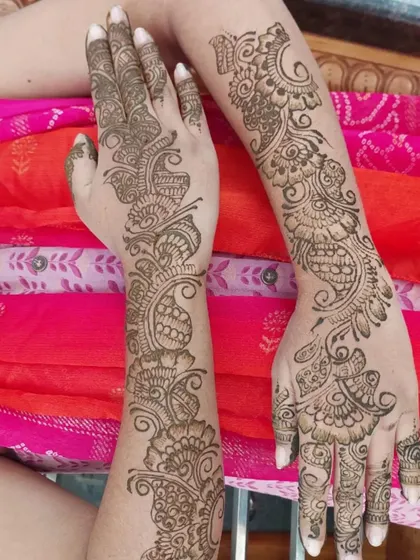The back of the hands for the Arabic-style baby shower design. The pattern continues the flowing floral and peacock theme, creating a cohesive and beautiful look from every angle.