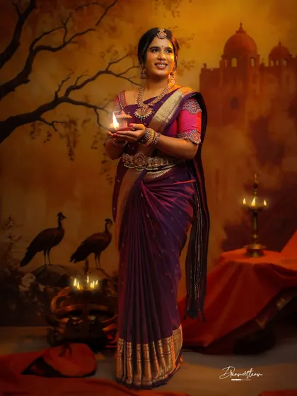 A beautiful concept shoot for my lovely client, Anjana. The theme was inspired by classic paintings, and I created a traditional look with a deep purple saree, temple jewelry, and a glowing lamp to set the mood.