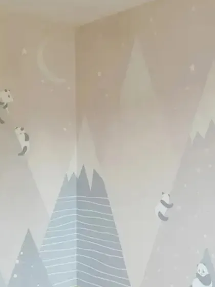 A calming nursery wallpaper with a minimalist mountain and panda design, perfect for creating a peaceful environment for a baby's room.